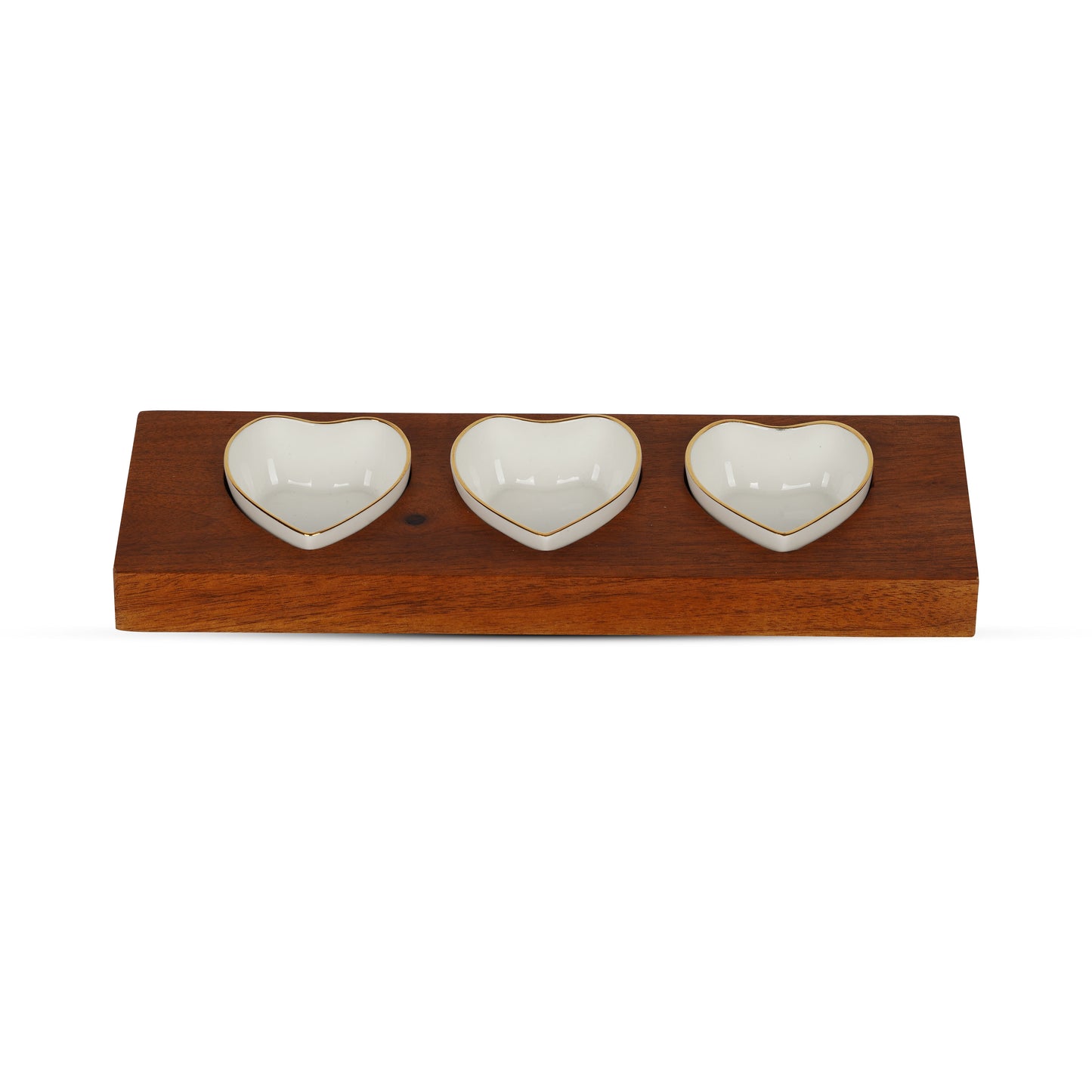 Three heart-shaped bone china chutney bowls with pure gold lines on a wooden serving tray